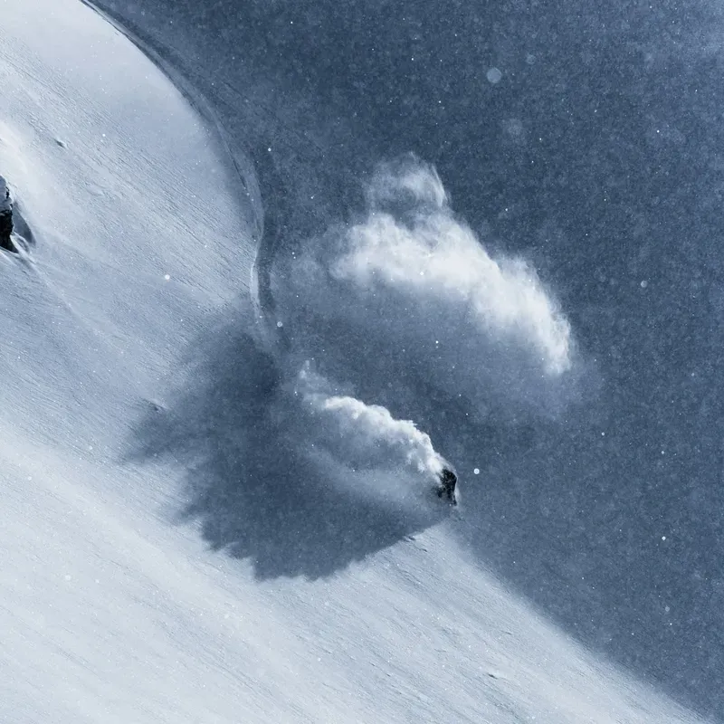 skier ripping down a snowy mountain